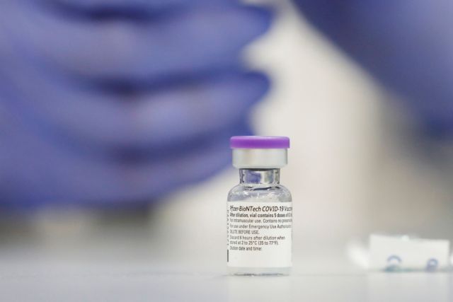 A vial of the Pfizer vaccine against the coronavirus disease (COVID-19) is seen as medical staff are vaccinated at Sheba Medical Center in Ramat Gan, Israel December 19, 2020. Picture taken December 19, 2020. REUTERS/Amir Cohen